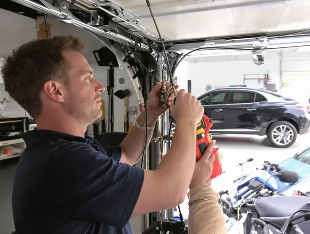 Worthington Garage Door Repair safety certified technician performing cable replacement in Worthington